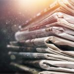 Pile of newspapers on white background